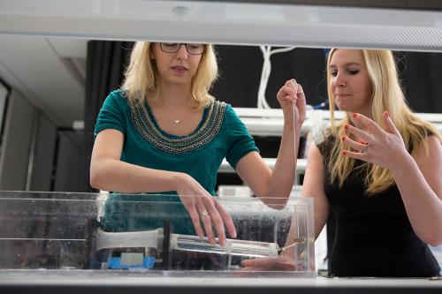 Professor and student conducting experiment in fluid mechanics in lab